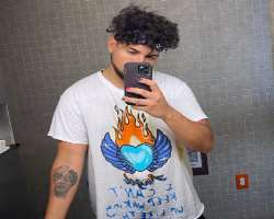 He has a big tattoo on his forearm which shows he is a tattoo lover.